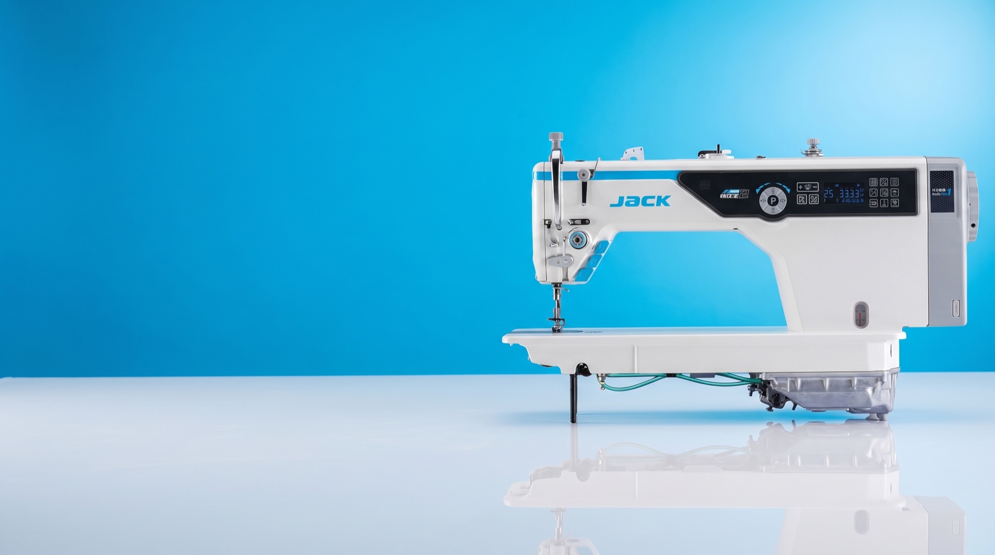 Jack A5E-B single-needle lockstitch industrial sewing machine on a vivid azure studio panel